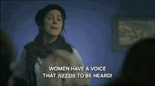 a woman in a beret says women have a voice that needs to be heard while pointing