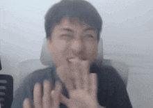 a blurry image of a man making a funny face