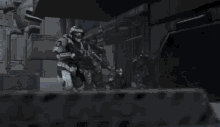 a robot is flying through the air in front of a pile of concrete blocks