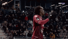 two soccer players are hugging each other and one has a shirt that says mosl
