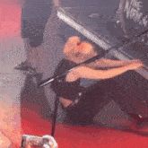 a woman is sitting on the floor in front of a drum set that says the warner