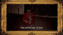 a framed picture of a man in a red jacket with the words fuck all the talk in time