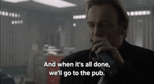 a man smoking a cigarette and saying " and when it 's all done we 'll go to the pub . "