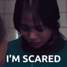a woman in a blue shirt with the words i 'm scared on the bottom