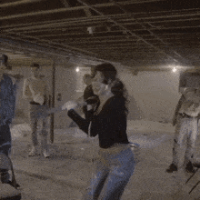 a woman is squatting down holding a large hammer