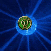 a disco ball with a green coin on it and the words mantap puooll written on it