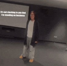 a woman is standing in front of a screen that says it 's not clocking to you that i 'm