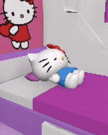 a hello kitty doll is laying on a bed in a room