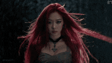 a woman with red hair is wearing a choker and a necklace