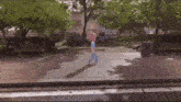 a person walking down a sidewalk with a pink cotton candy