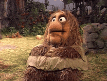 a stuffed animal with a beard is tied up in a blanket