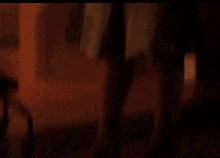 a woman in a blue top is standing in a room