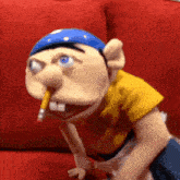 a puppet with a pencil sticking out of his nose