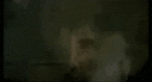 a blurry picture of a person with a white shirt on .