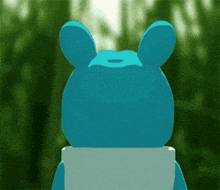 a blue teddy bear with a white shirt on