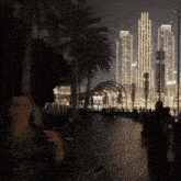a blurred image of a city at night with a few people walking