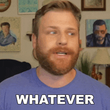 a man with a beard is wearing a blue shirt and says whatever