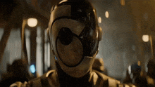 a close up of a person wearing a helmet with a circle in the middle