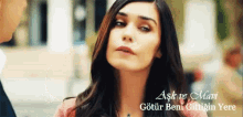 a close up of a woman 's face with the words aşk ve mari on the bottom right