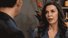 a woman looks at a man while another woman looks on