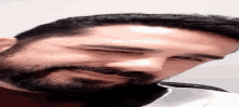 a man with a beard is laying on his back