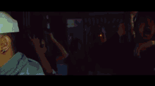 a pixelated image of a man drinking from a bottle with the letter l on it