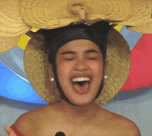 a woman wearing a straw hat with a cat on it