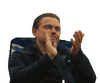 a man in a blue shirt is clapping his hands