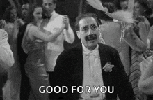 a man in a tuxedo is dancing with a crowd of people at a party and saying `` good for you '' .