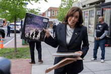 a woman holding a book that says " below mischief " on it