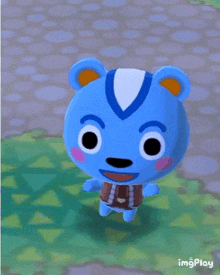 a blue bear with a white stripe on its head is standing on a stone path .