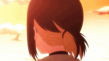a close up of a person 's back with a ponytail