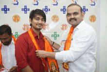 a man is being pinned to another man 's neck in front of a wall with jmd logos on it