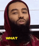 a man with a beard is wearing a red hoodie and saying what .