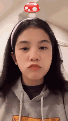 a girl with a mushroom headband on her head