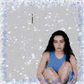 a woman in a blue tank top sits on the floor with the words i have above her