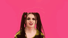 a blurry picture of a woman wearing a yellow and black striped sweater on a pink background