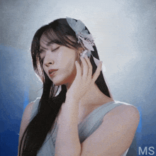 a woman with a feather in her hair and the word ms below her