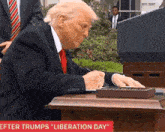 a man in a suit and tie is sitting at a desk with the words " after trumps liberation day " on the bottom