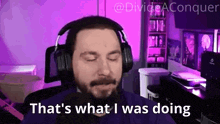 a man wearing headphones is saying that 's what i was doing while sitting in front of a computer .