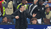 a man in a black jacket stands in front of a sign that says ' stour sports ' on it