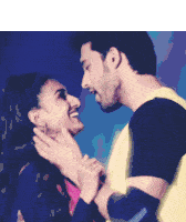 a man and a woman are looking into each other 's eyes and smiling