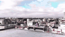 a group of people are standing on top of a building