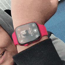 a man wearing a red apple watch is listening to a song called chihuahua