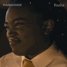 a close up of a woman 's face with the hulu logo in the background