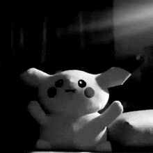 a black and white photo of a stuffed animal that looks like a pikachu