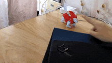 a person is playing with a toy on a desk that has a sticker on it that says ' nintendo ' on it