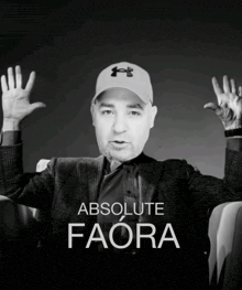 a black and white photo of a man wearing an under armour hat with the words absolute faora below him