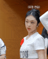 a woman wearing a white shirt that says tmoot on it