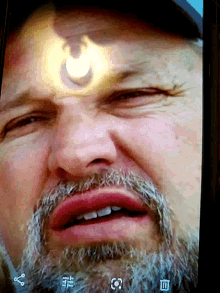 a close up of a man 's face with chinese characters on the bottom right corner